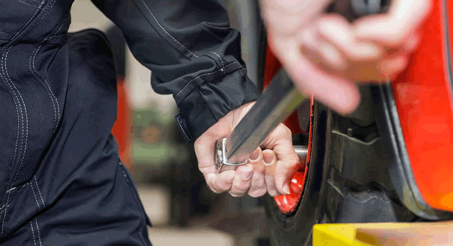 Workers are repairing wheels with torque wrenches